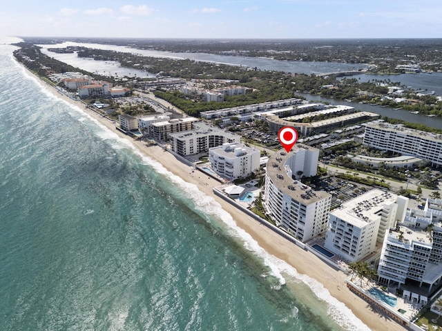 aerial view with a water view and a view of the beach