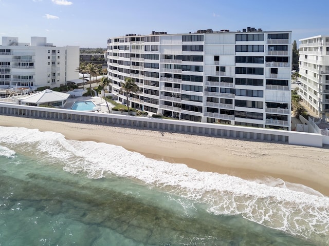 view of property with a view of the beach and a water view