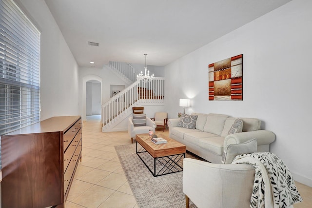 living room featuring light tile patterned flooring and an inviting chandelier