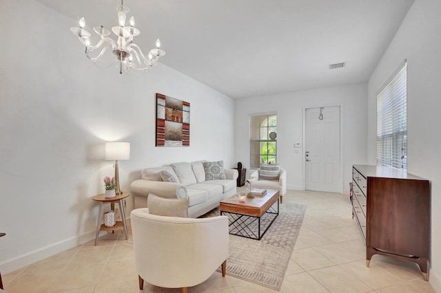 living room featuring a notable chandelier and light tile patterned flooring