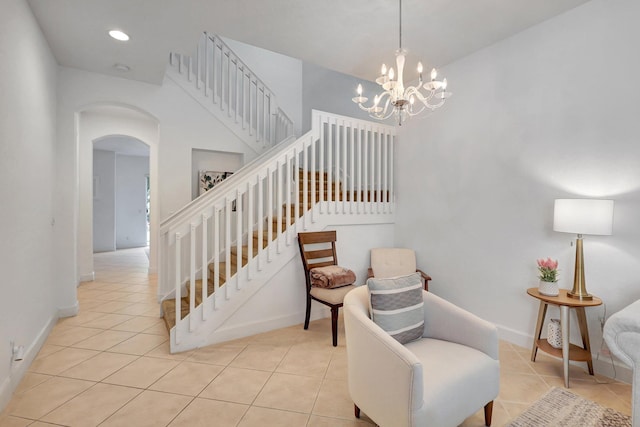 stairs featuring tile patterned floors and a chandelier