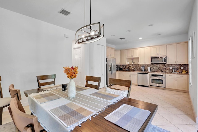 dining room featuring light tile patterned flooring and an inviting chandelier