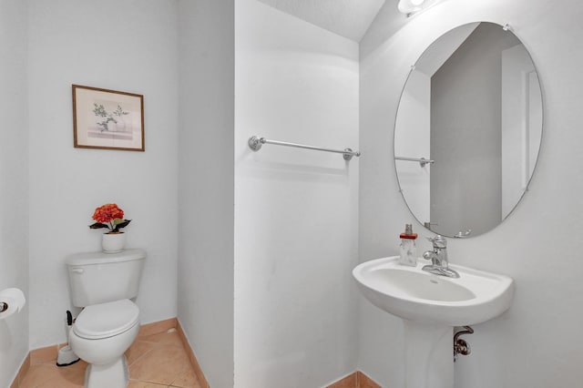 bathroom featuring tile patterned floors, a textured ceiling, and toilet