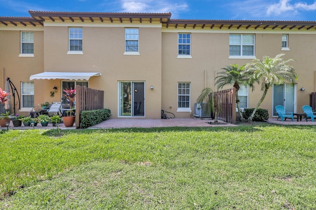 back of house featuring a yard and a patio