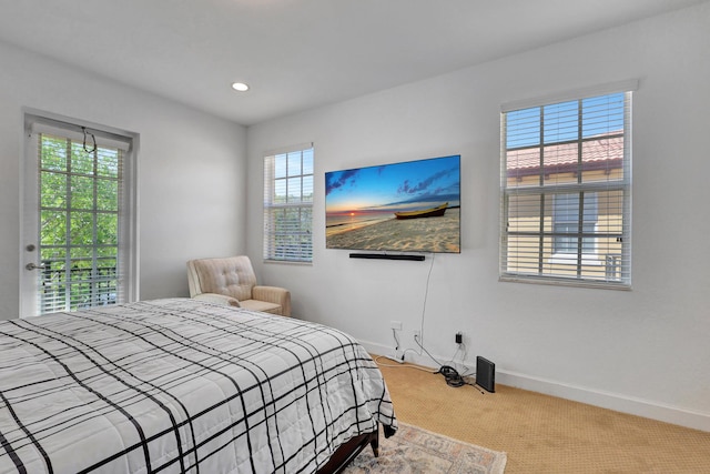 bedroom with light carpet and access to exterior