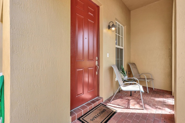 view of exterior entry featuring a porch