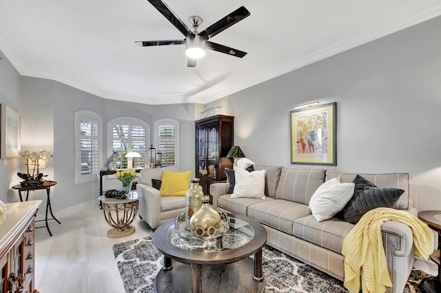 living room with hardwood / wood-style flooring, ceiling fan, and ornamental molding