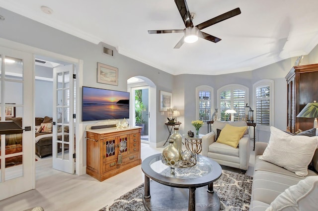 living room with ceiling fan, french doors, and crown molding