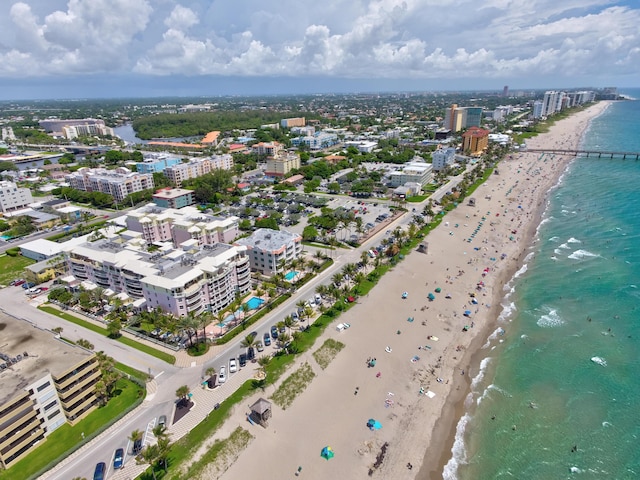 drone / aerial view with a beach view and a water view