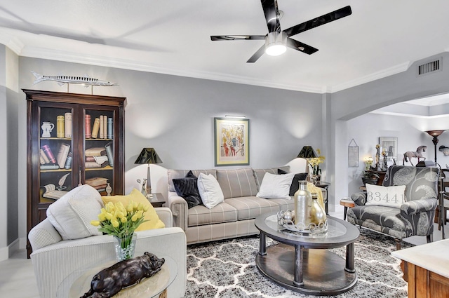 living room with ceiling fan and crown molding