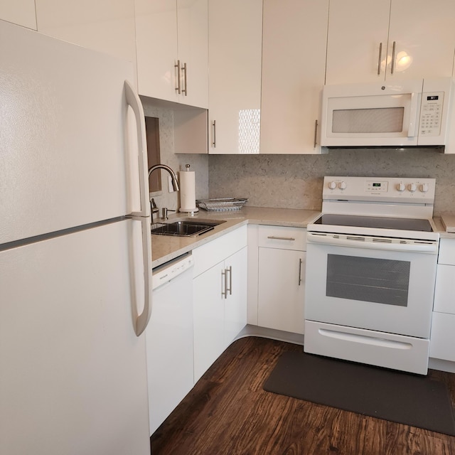 kitchen featuring tasteful backsplash, white appliances, dark wood-type flooring, sink, and white cabinets