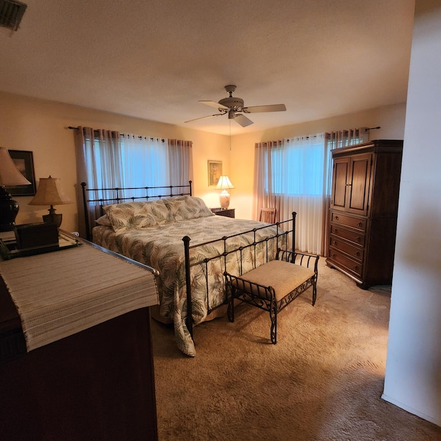 bedroom featuring light colored carpet and ceiling fan