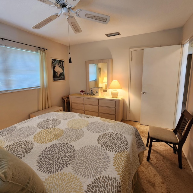 bedroom with ceiling fan and light carpet