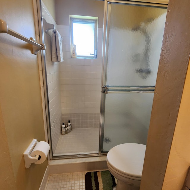 bathroom featuring toilet and walk in shower