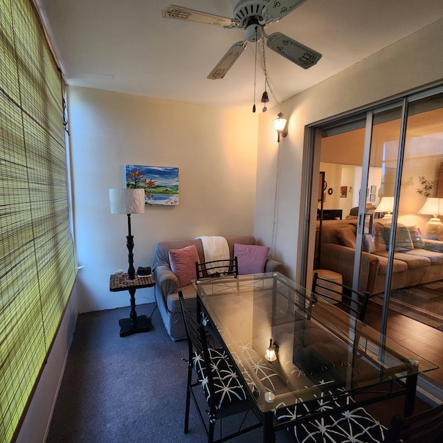 carpeted dining space featuring ceiling fan