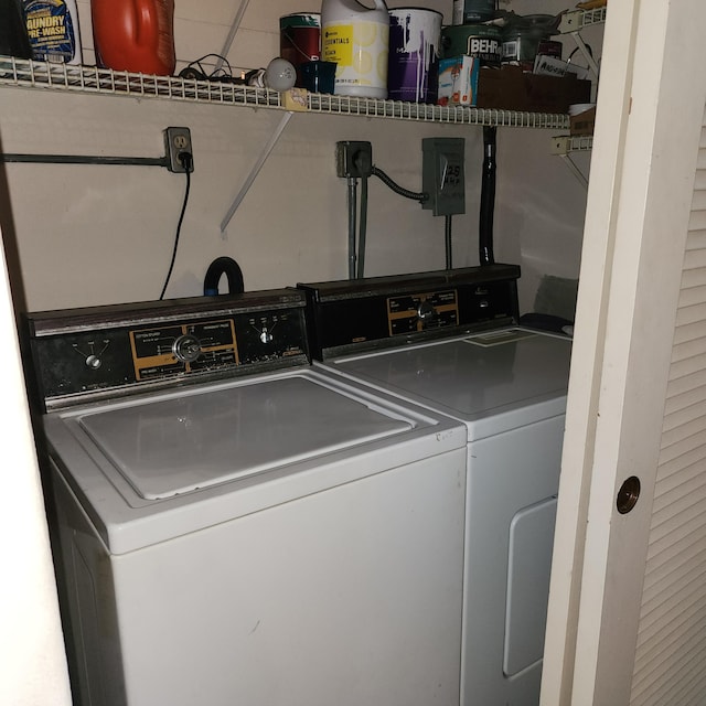 clothes washing area with washing machine and clothes dryer