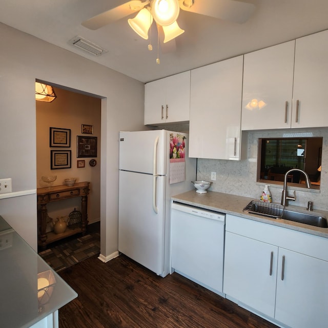 kitchen featuring backsplash, white appliances, dark wood-type flooring, sink, and white cabinets