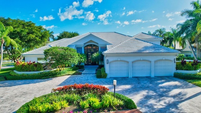 view of front of house with a garage and french doors