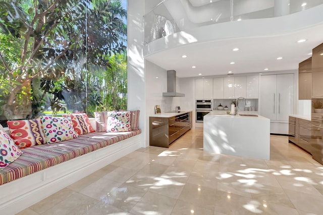 living room featuring a towering ceiling and sink