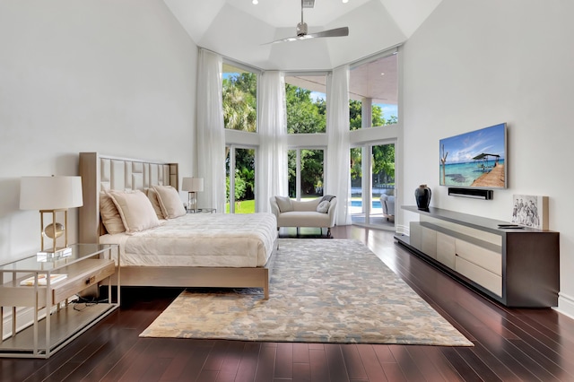 bedroom with a high ceiling, access to outside, ceiling fan, and dark wood-type flooring