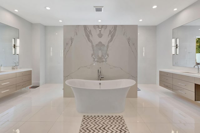 bathroom with a washtub and vanity