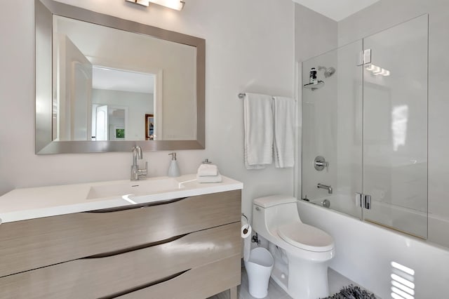 full bathroom featuring shower / bath combination with glass door, vanity, and toilet