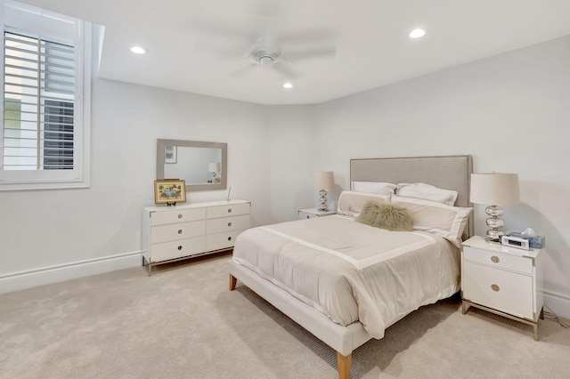 bedroom with ceiling fan and light colored carpet