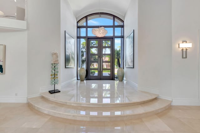 foyer with french doors and a towering ceiling