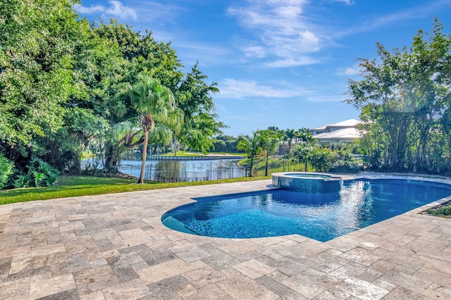 view of pool featuring a lawn, a patio area, an in ground hot tub, and a water view