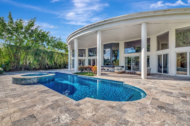 view of pool with outdoor lounge area, a patio area, and an in ground hot tub