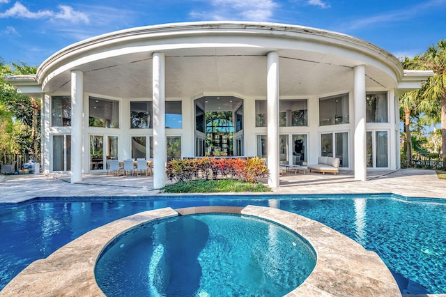 view of pool featuring an in ground hot tub and a patio area