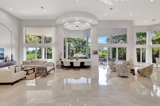 living room featuring a towering ceiling