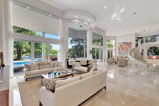 living room featuring light tile patterned flooring and a towering ceiling