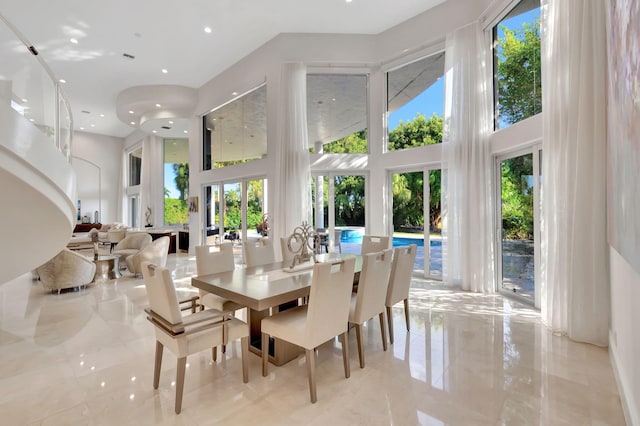 dining area featuring a towering ceiling