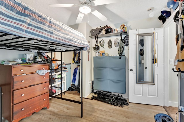 bedroom featuring ceiling fan, a closet, and light hardwood / wood-style floors