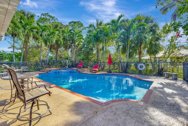 view of swimming pool with an in ground hot tub and a patio