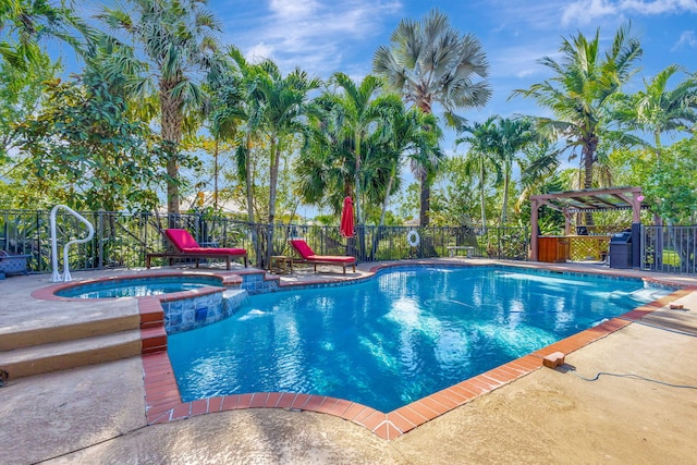 view of swimming pool featuring an in ground hot tub and a patio