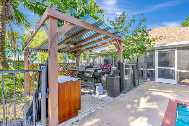 view of patio / terrace with a sunroom and a hot tub