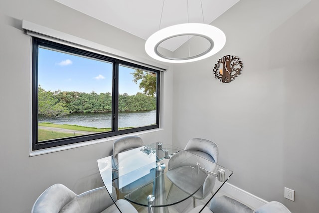 dining room featuring a water view