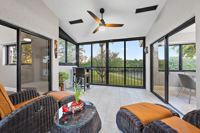 sunroom featuring ceiling fan and lofted ceiling