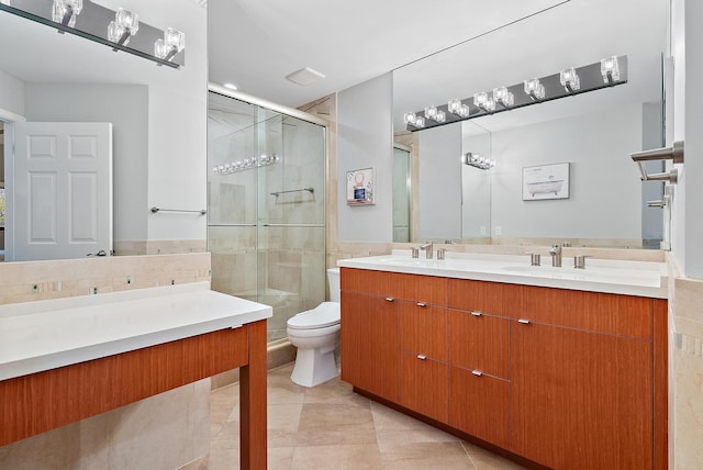 bathroom featuring tile patterned floors, vanity, toilet, and an enclosed shower