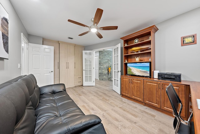 living room featuring ceiling fan, french doors, and light hardwood / wood-style flooring