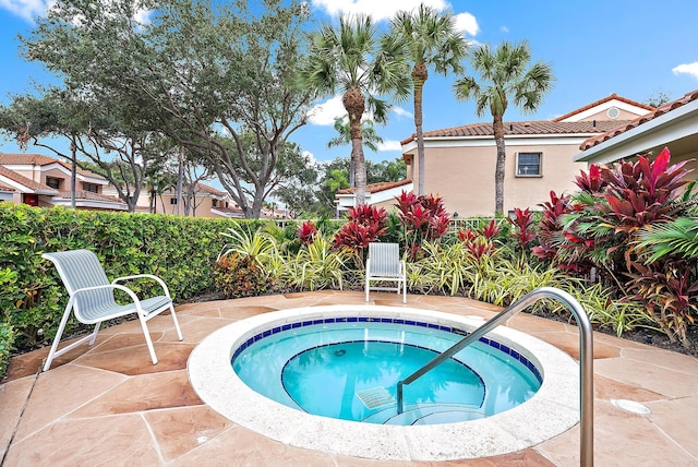 view of pool with a patio area and an in ground hot tub