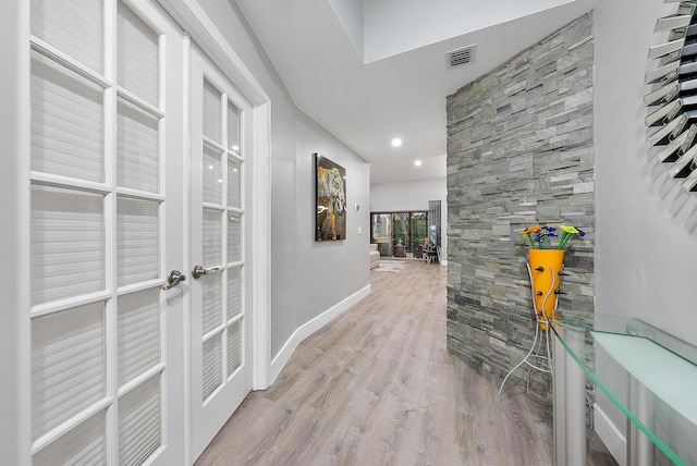 hall with light hardwood / wood-style floors