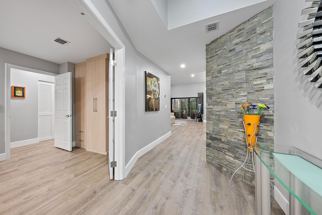 corridor with light hardwood / wood-style floors