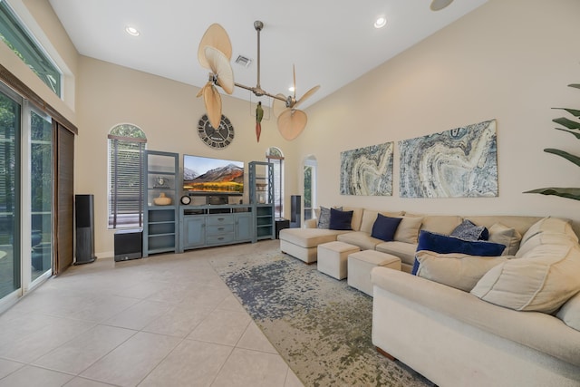 living area featuring recessed lighting, a high ceiling, and tile patterned floors