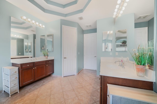 full bathroom with visible vents, two vanities, and a sink