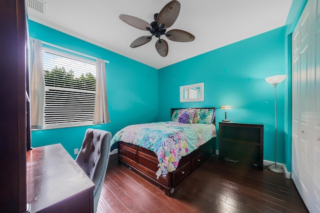 bedroom featuring hardwood / wood-style floors, a closet, visible vents, and baseboards