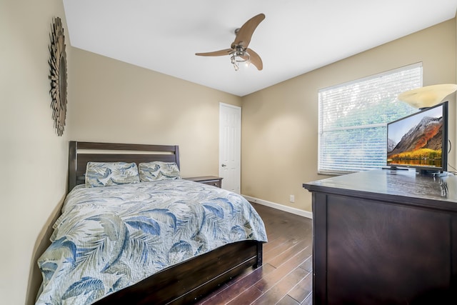 bedroom with dark wood finished floors, baseboards, and ceiling fan