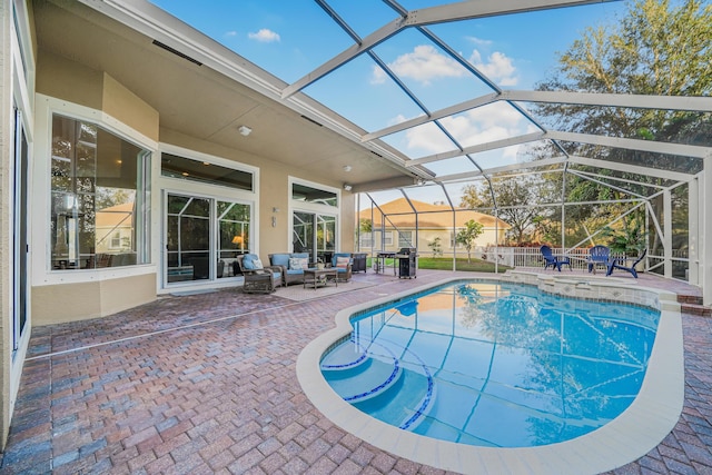 pool featuring a lanai, an outdoor hangout area, and a patio